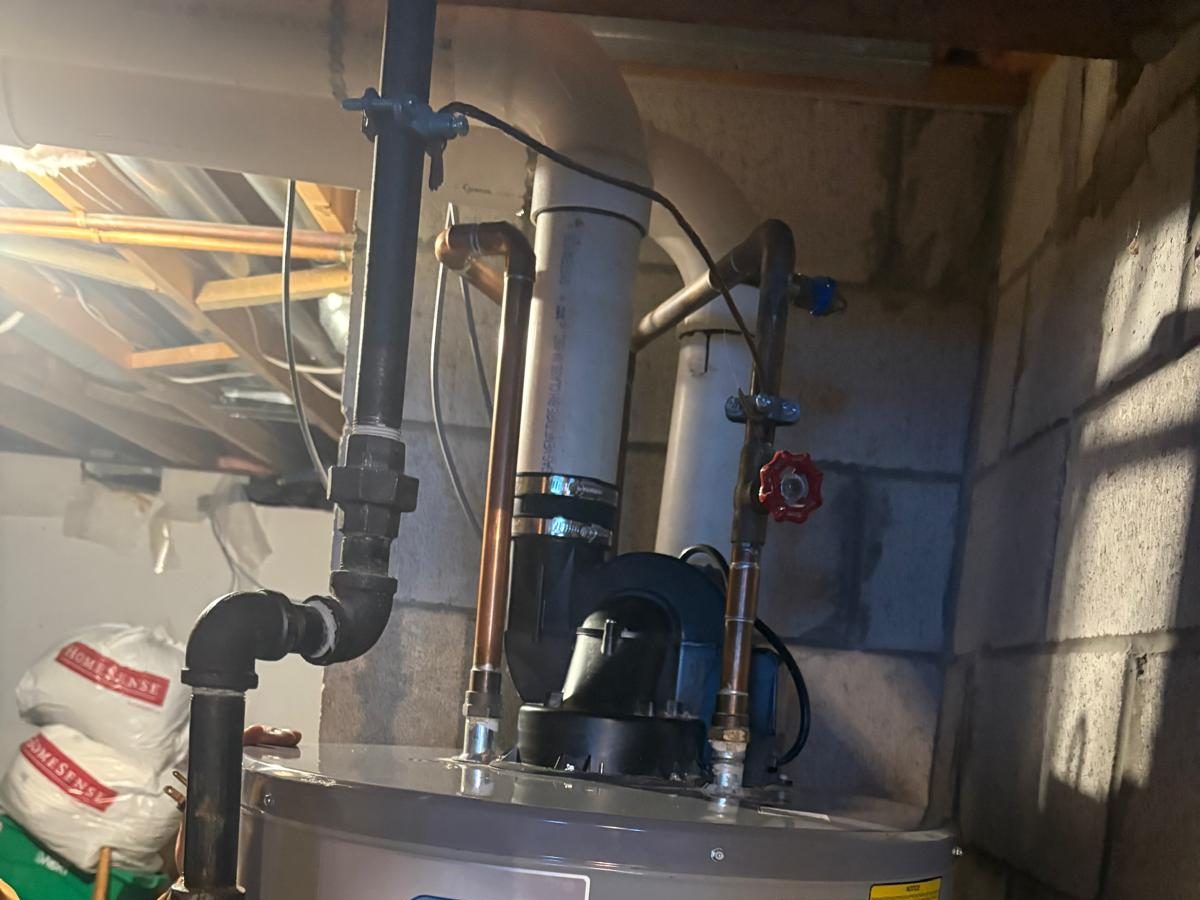Gas water heater with venting and piping in a basement